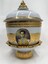 Side of decorative vase with images and inscription