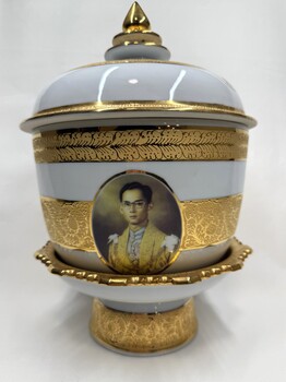 Side of decorative vase with images and inscription