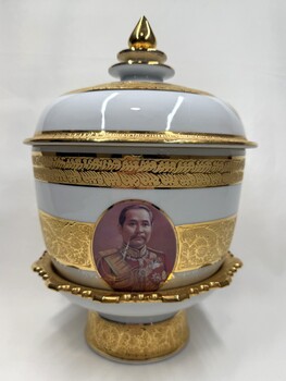 Side of decorative vase with images and inscription