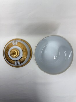 Decorative vase with images and inscription with lid removed from above