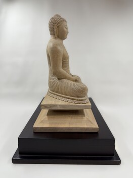 Image of side of wooden statue of the Buddha