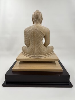 Image of back of wooden statue of the Buddha
