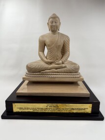 Image of front of wooden statue of the Buddha