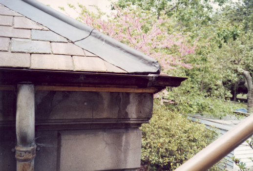 Corner of slate roof with downpipes
