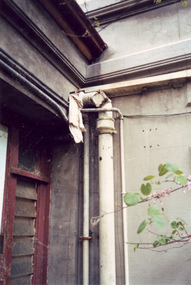 Photograph - Exterior cast iron pipe beside louvre window, c.1987