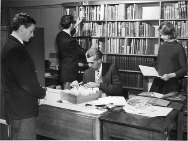 Photograph - Black and white print, Students and Staff Member in the Library, Unknown