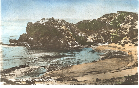 Rocky outcrop above a small sandy cove 