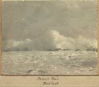 Wild se with large wave crashing over reef