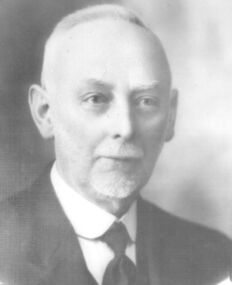 Black and white portrait of a male with a goatee beard