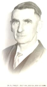 Formal portrait of Councillor P.J.Farley in dark suit and wide striped tie 