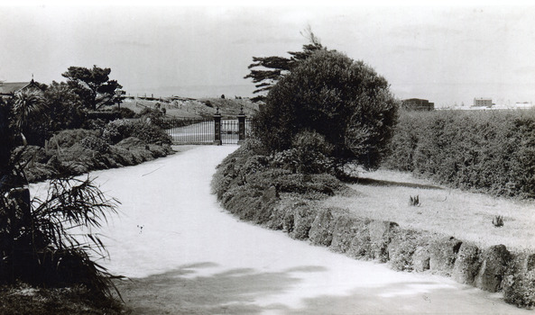 Black and white photograph of the entrance to the gardens . This is an enhanced copy