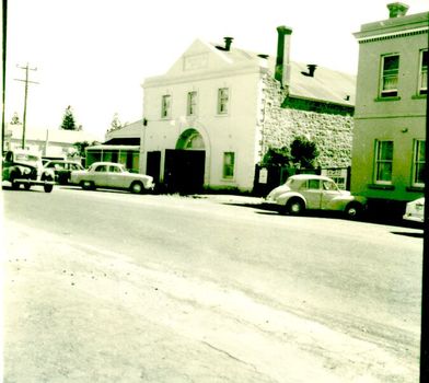 The drill hall a two storied rendered building with double doors opening into the street