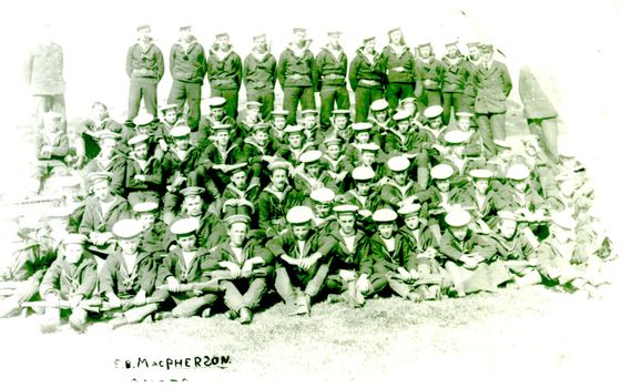 Group of men in naval uniforms posed