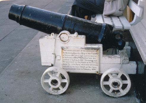 cannon with white painted carriage and four heavy metal wheels supposedly from the Sir John Byng located outside Port Fairy Library 