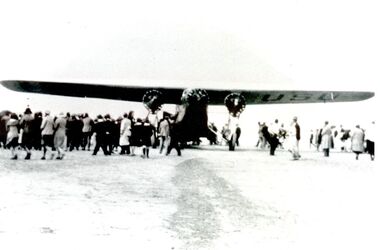 aeroplane surrounded by a crowd of people