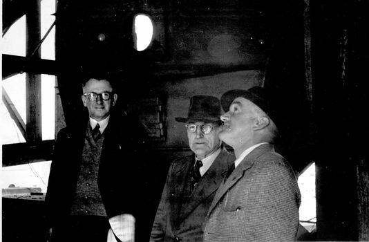 Mr  Jack McLaren and two men in hats inspecting the interior of the Cement Works