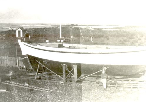 Bill Haldane standing with his boat Amaryllis as it nears completion on Griffith Island