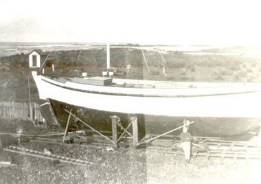Bill Haldane standing with his boat Amaryllis as it nears completion on Griffith Island