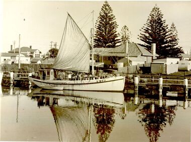 Fishing boat ‘Inverness’ with sail furled berthed at lower end of wharf
