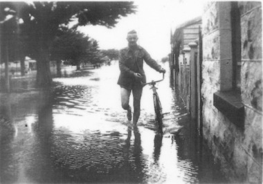 Male walking a bicycle on footpath