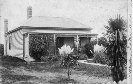 Early weatherboard home with verandah at front 