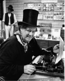 Gentleman at typewriter wearing top hat