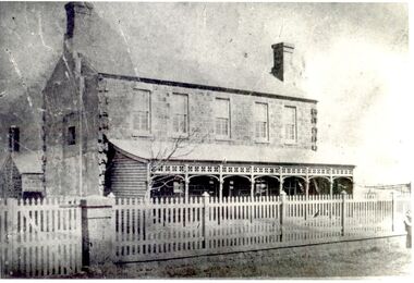 Bluestone 2 story building with verandah and paling fence