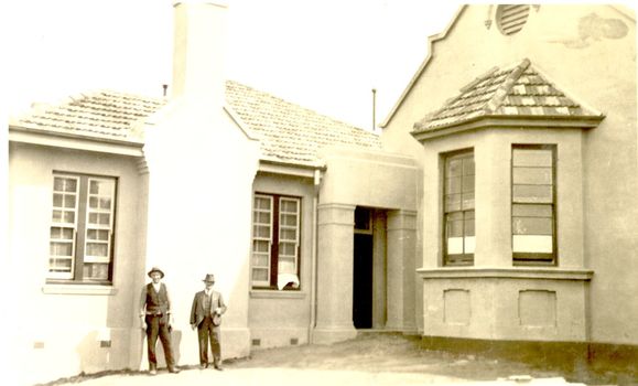2 males outside the new extension to the hospital