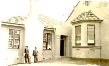 2 males outside the new extension to the hospital