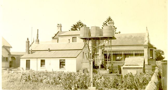 Buildings at the back of the hospital with large tank stand