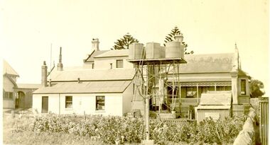 Buildings at the back of the hospital with large tank stand