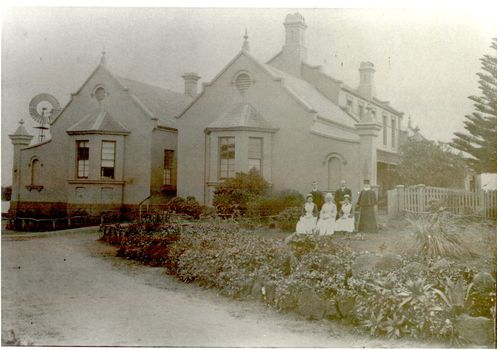 New addition to the hospital with i’ts bay windows. 5 women and two men posed to the side