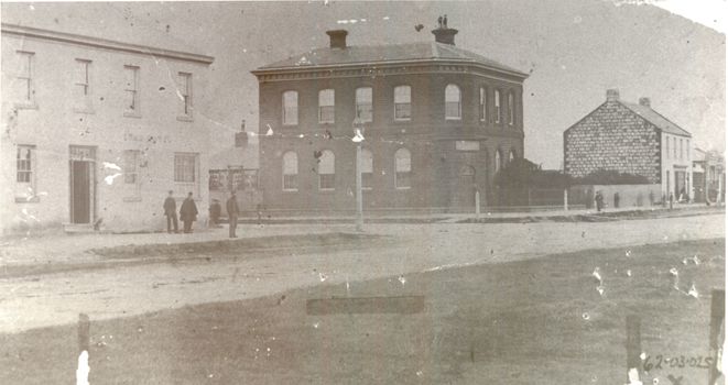 Two story bluestone Bank of Australasia in centre,  two story Rendered Stag Hotel on left and 2 story Bank hotel on right