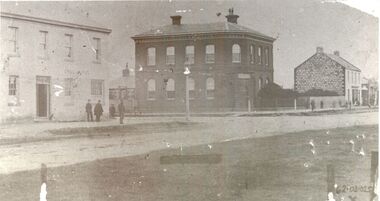 Two story bluestone Bank of Australasia in centre,  two story Rendered Stag Hotel on left and 2 story Bank hotel on right