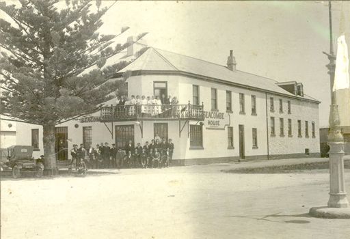 Two story rendered Seacombe House with Staff outside