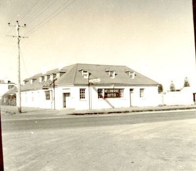 2 story building with dormer windows on corner 