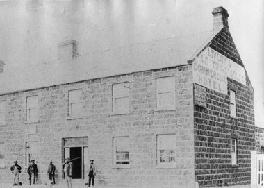 Two story bluestone Commercial hotel with 5 males on footpath