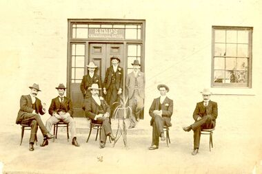 8 males outside the entrance to the Commercial hotel