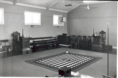 Black and white photograph of the interior showing the carpet  and the lewis 