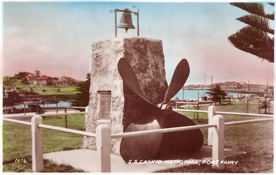 Bluestone memorial stone with ship’s propeller attached and brass plaque attached surrounded by a pipe fence