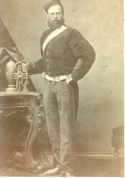 Black and white photograph of A male in a uniform with a sash across his chest