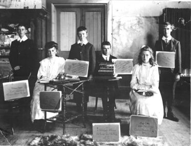 2 females and 4 males formally posed with musical instruments and their certificates