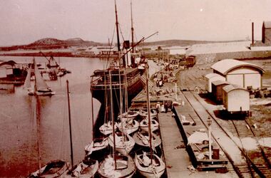Couta boats moored around ship at wharf