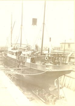 S.s.Casino in dry dock with a man working on a ladder on the left side of the ship