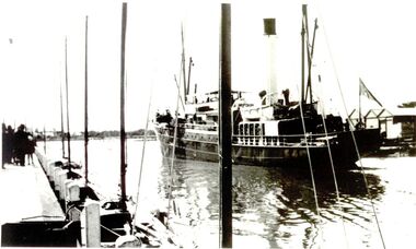 Ship coming up river to berth at wharf harbour sheds on the right