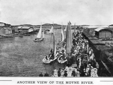 Moyne river with people lining the wharf having arrived by the train on the right  to board the couta boats for trips around the bay 