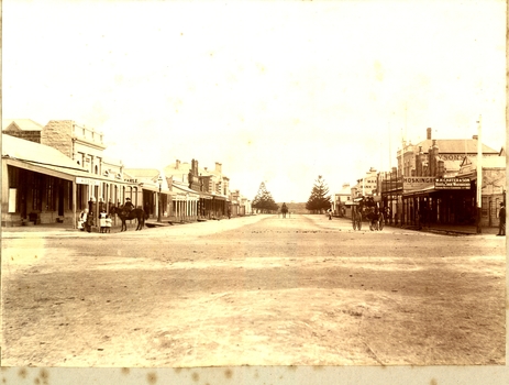 Sackville Street port Fairy showing shops on either side with a family and their horse on one side and a carriage on the other