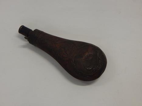 An embossed copper powder flask 