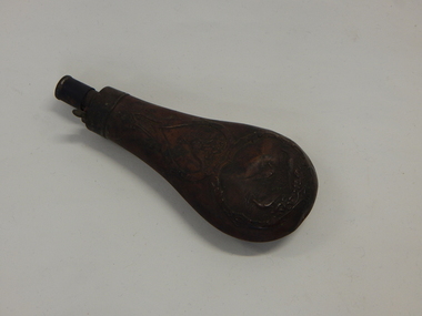 An embossed copper powder flask 