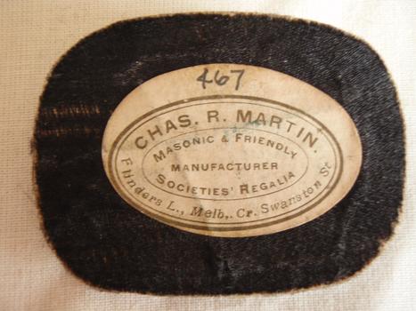 underside of the hat badge with the details of the manufacturer Chas.R.Martin 